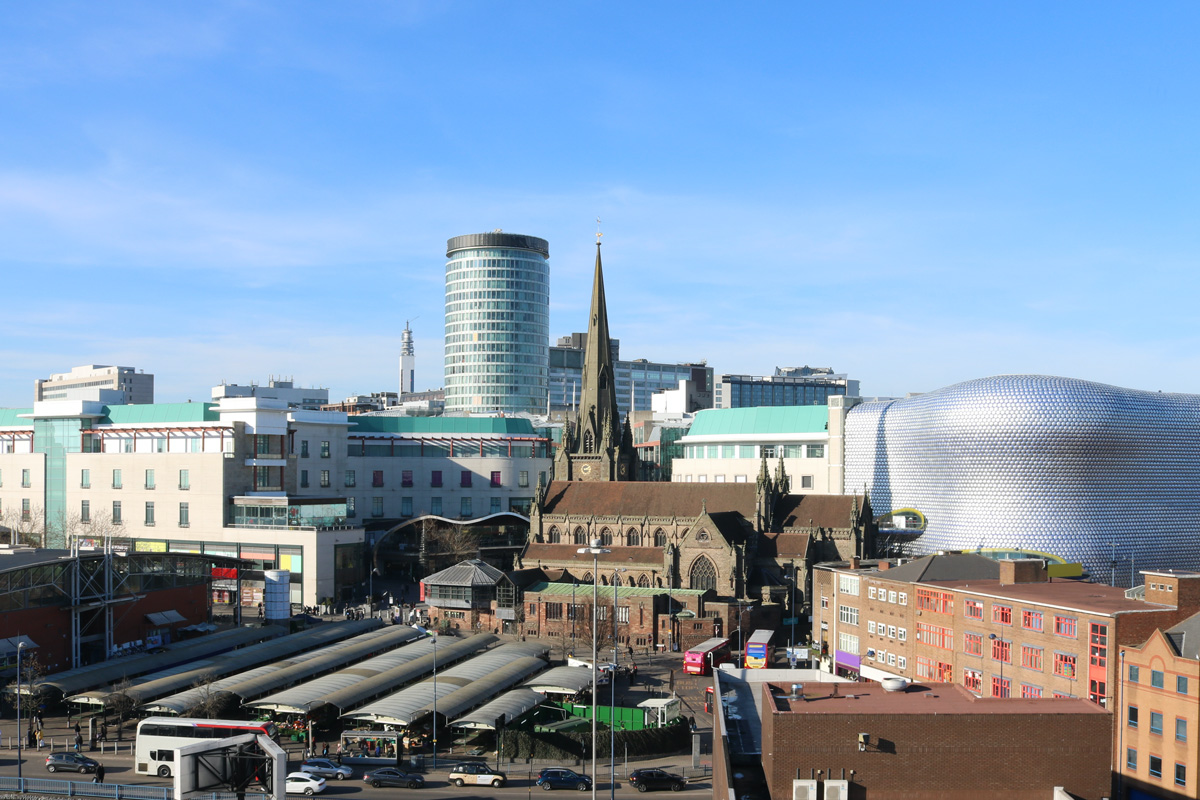 Birminham's city centre skyline. Landmarks such as the Rag Market, the Church of St Martin in the Bull Ring, the Rotunder and The Bullring itself, are all in view.