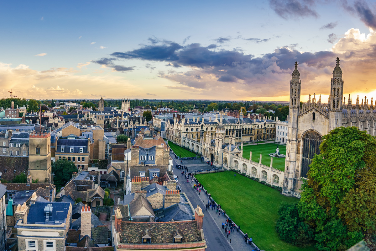 An aerial photograph of the city of Cambridge, taken at the sun sets. Kings College Chapel sits to the right.