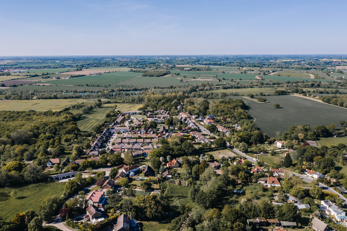 An aerial view of one of Chelmsford's residential housing estates, sat within the Essex countryside. Photograph taken by a drone on a bright, summer day.