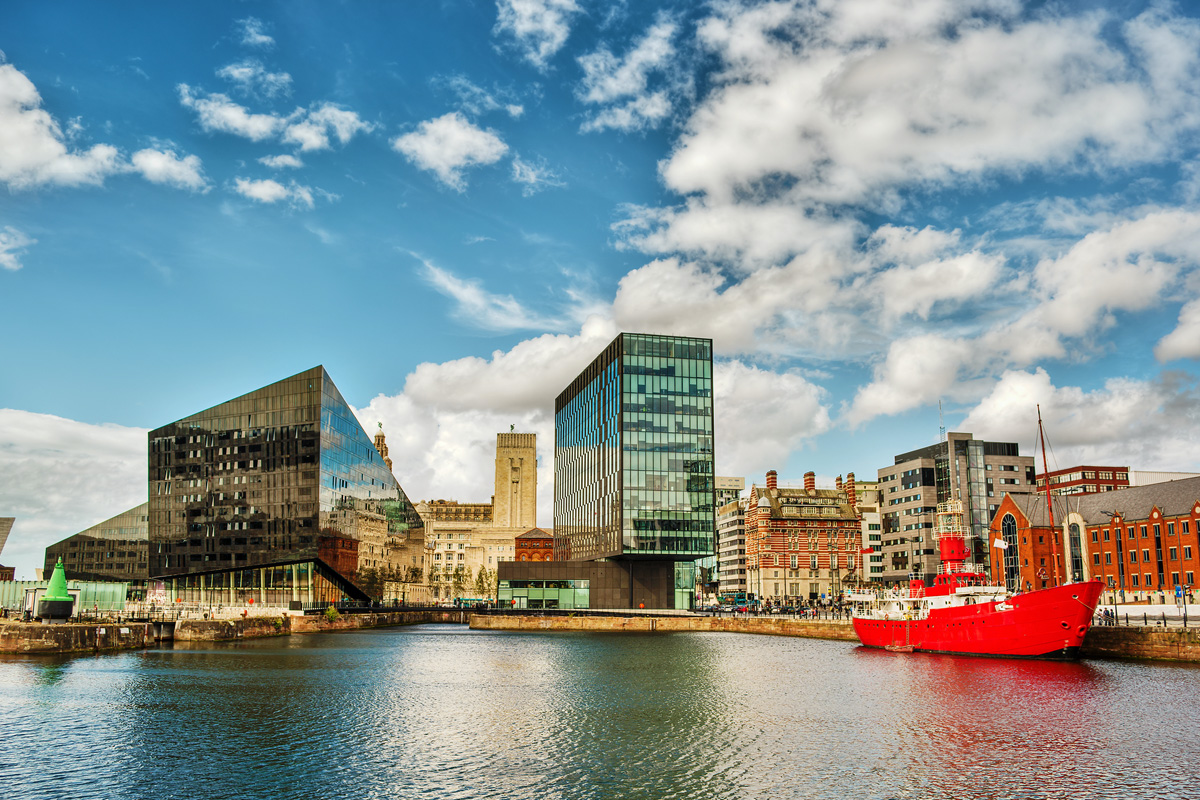 The view across Canning Dock in Liverpool with the old bar Lightship to the right and the Liver Building in the background. Canning Dock is on the River Mersey and part of the Port of Liverpool.