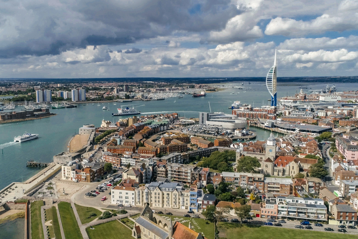 An aerial view of the city and the bay of Portsmouth. Photograph taken in summer. Spinnaker Tower is clearly visible.