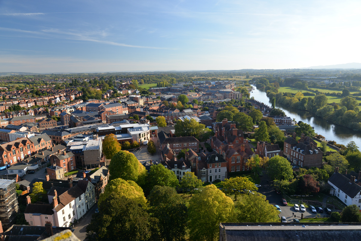 An aerial view of the city of Worcester in Worcestershire, West Midlands. Residental and commercial buildings sit alongside the River Severn.
